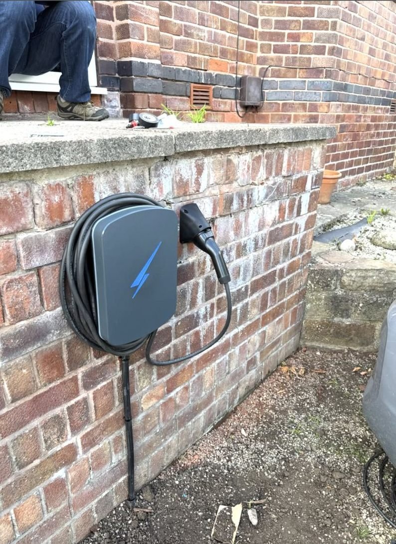 EV charger on a garden wall