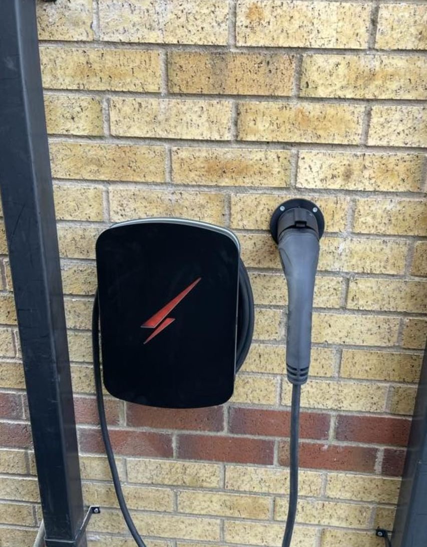 Black EV charger with tethered cable